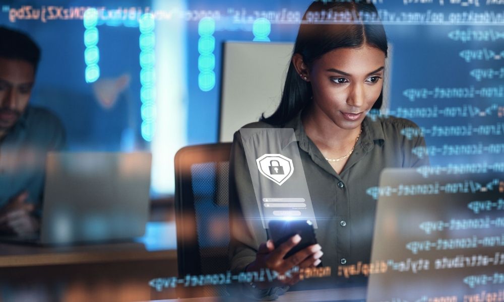 Cybersecurity professional using mobile and laptop with secure access interface overlay