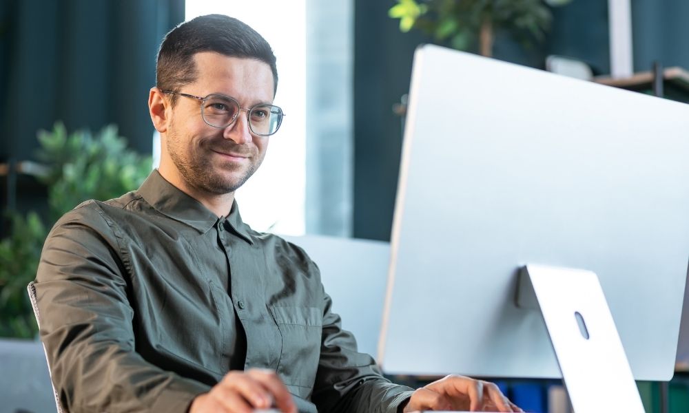 Professional IT specialist working at desktop computer in modern office environment