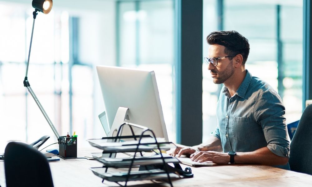 IT professional working at desktop computer