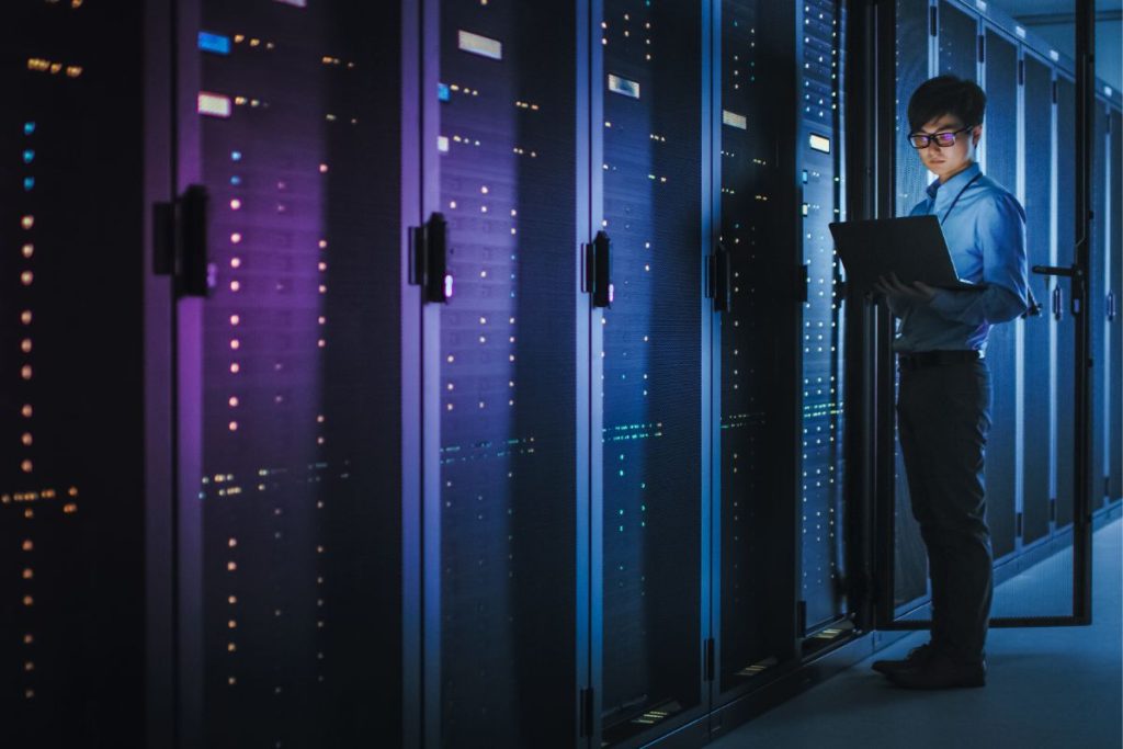 IT professional managing servers and monitoring infrastructure in a modern data center environment